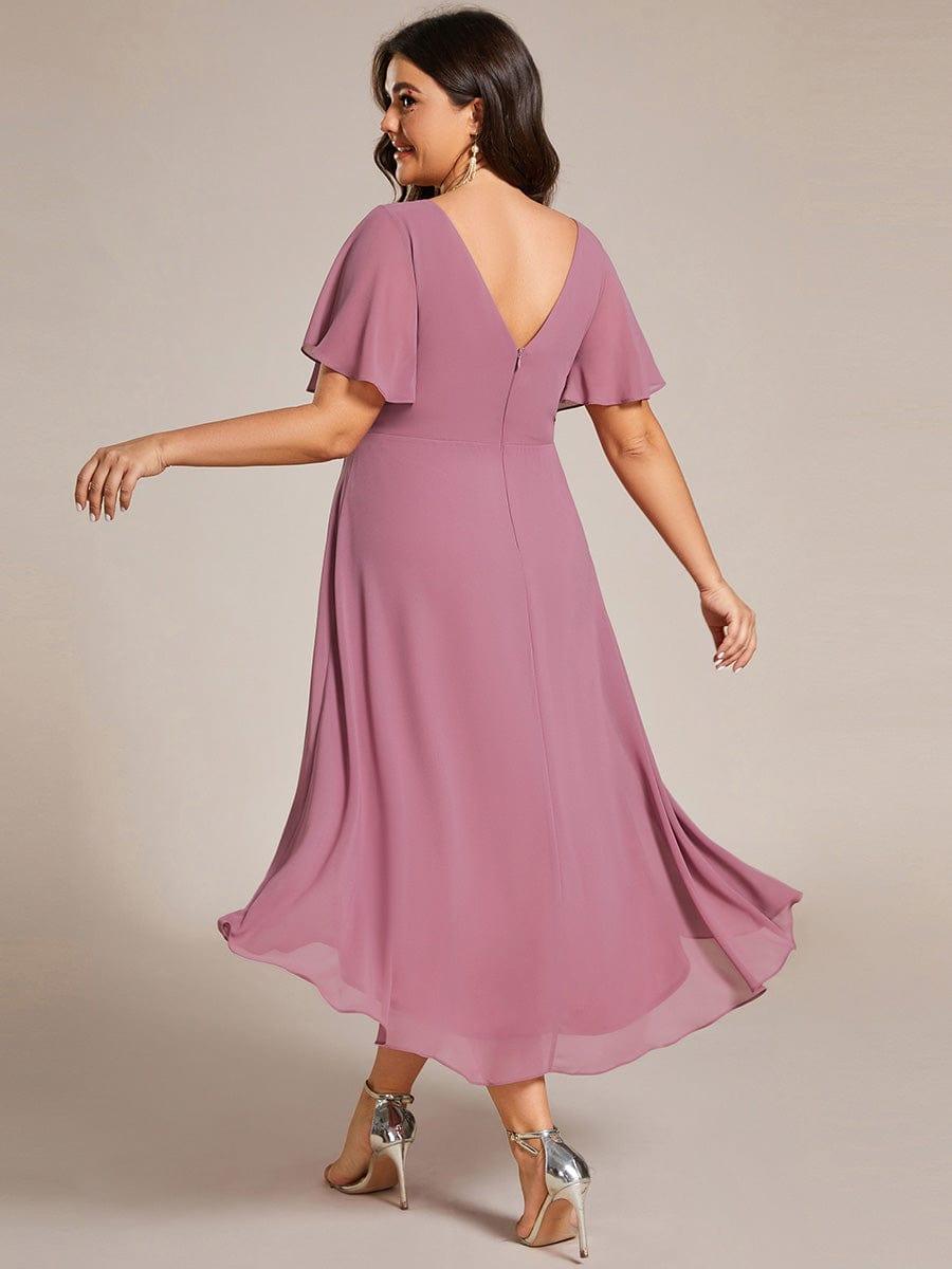 Back view of the mauve pink dress on a plus-size model, showing the V-shaped back with zip and flowing hem. 64