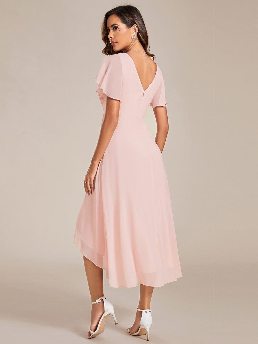 Back view of the pink dress, showing the V-shaped back opening, zip and layered high-low chiffon hem. 16