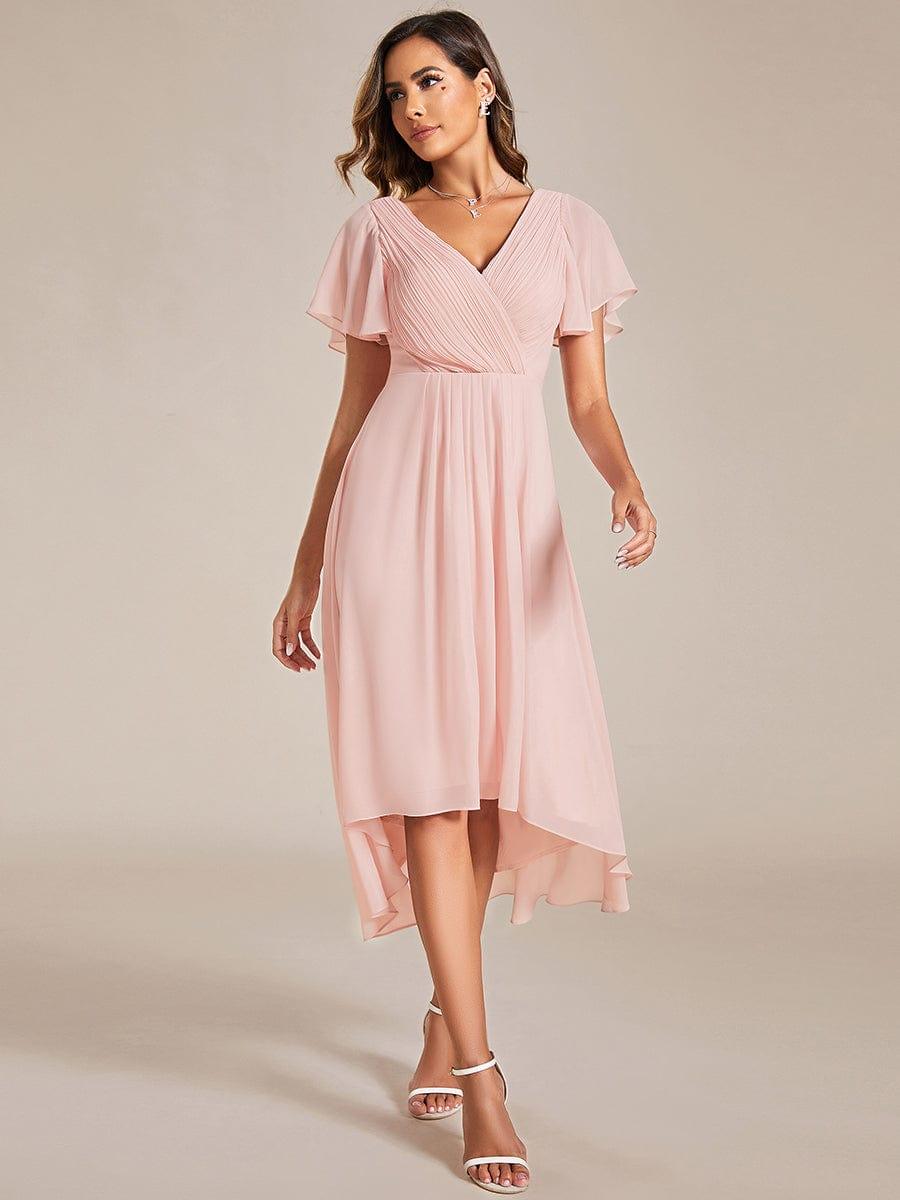 Pink dress worn by a model walking forward, showing the full chiffon skirt and short flutter sleeves. 20