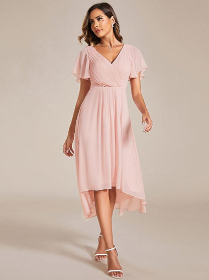 Pink dress worn by a model walking forward, showing the full chiffon skirt and short flutter sleeves. 20