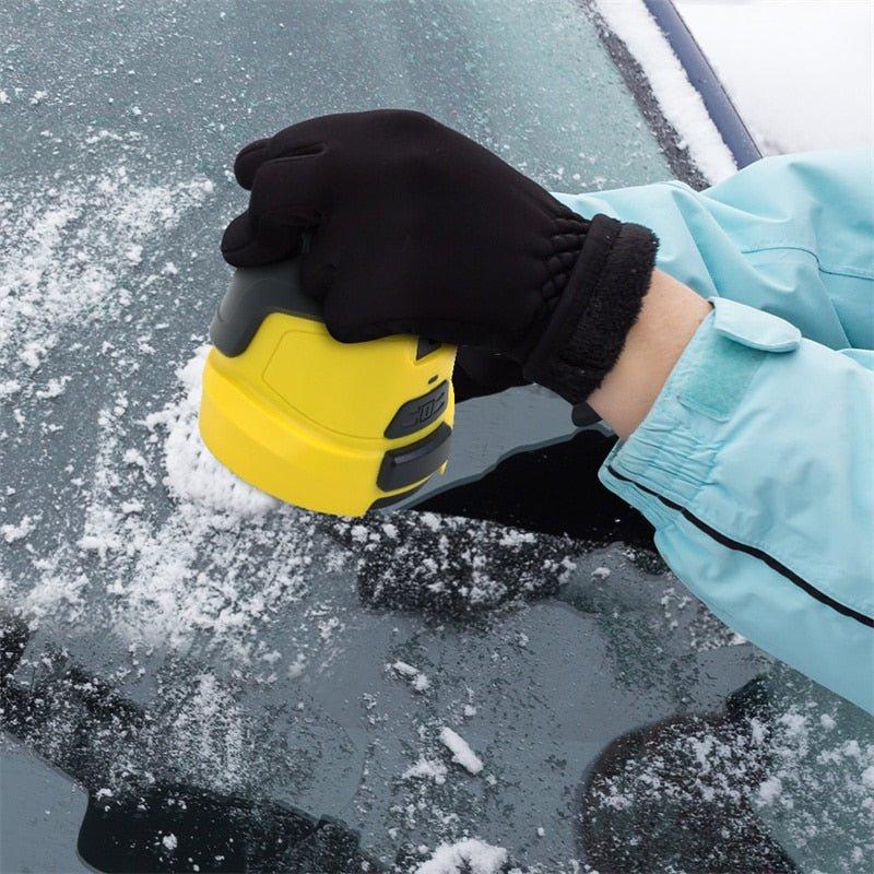 Hand in a black glove pressing the yellow scraper onto a snow-dusted car window 4