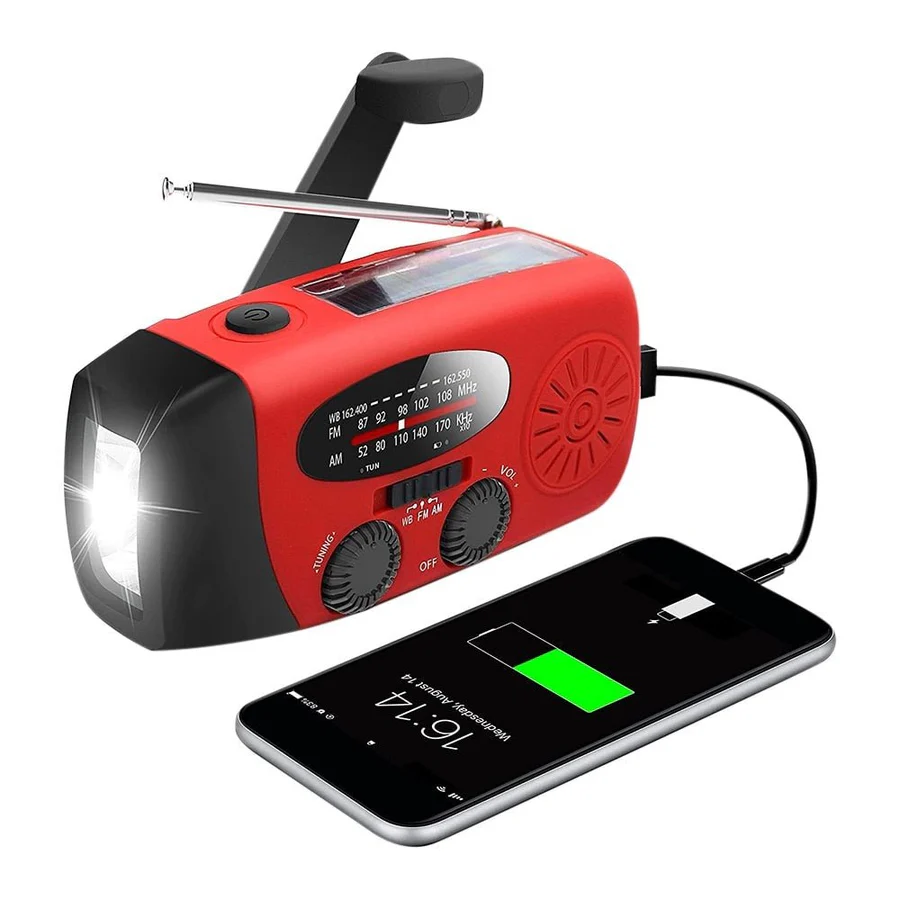 Red radio with torch lit and crank folded out, charging a smartphone by USB cable 1