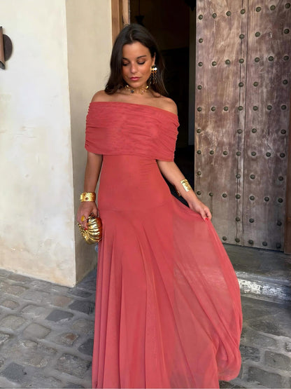 Model lifting the sheer terracotta skirt to show its flowing movement, off-shoulder neckline 8