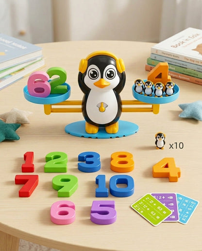 Penguin balance wearing yellow headphones on a round table, with loose numbers, small penguins and cards around it 9