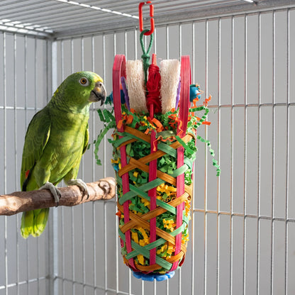 Toy hanging inside a wire cage while a green parrot on a wooden perch looks at it closely. 3