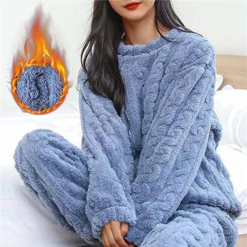 Model in the blue fleece set on a bed, with a flame graphic showing warmth 3