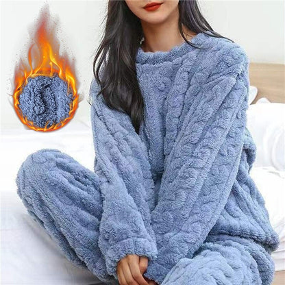 Model in the blue fleece set on a bed, with a flame graphic showing warmth 3