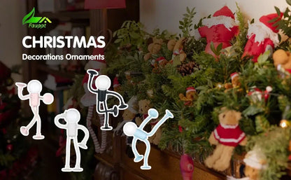 Four figure lights in pink, white, black and blue shown against a Christmas garland and soft toys 19