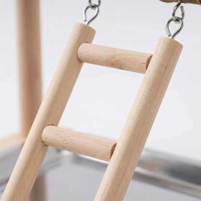 Close-up of the wooden ladder hanging from a branch by metal hooks, with the steel tray blurred beneath. 4