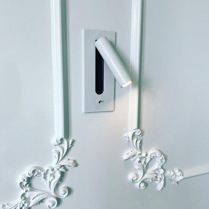 White wall light switched on, mounted on a white panelled wall with ornate plaster scrollwork 27