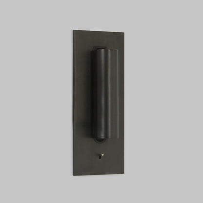 Dark bronze wall light with the tube folded flat against the plate, toggle switch below 2