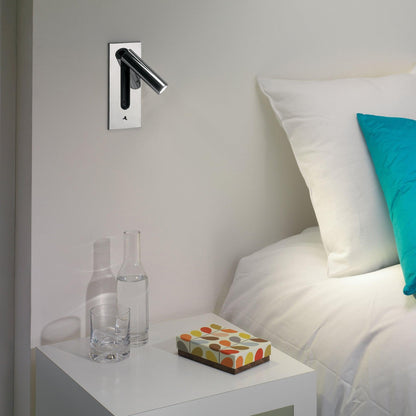 Dark wall light with the unlit swivel tube extended right and the toggle switch at the bottom 7