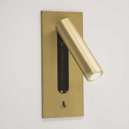 Matt gold wall light with LED tube pointing down to the right, shown on a white wall 26