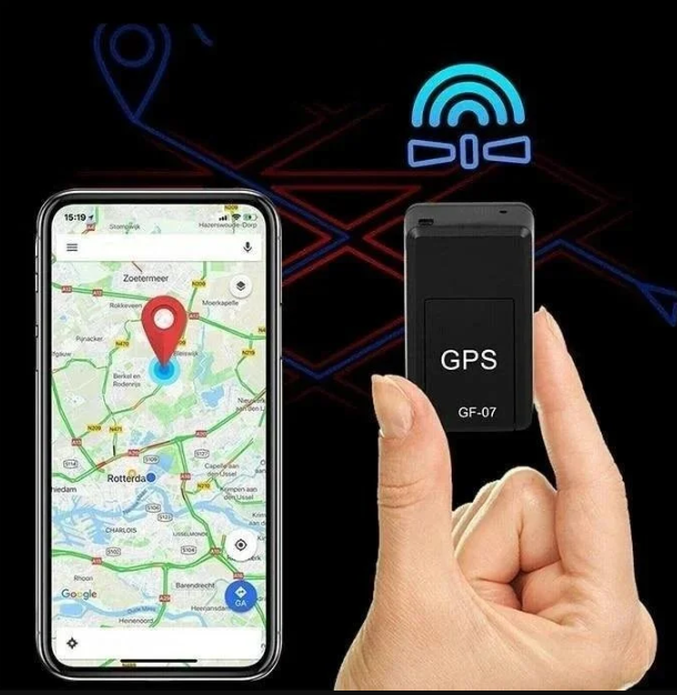 Hand holding the small black tracker next to a smartphone displaying a map with a red pin, against a dark background with signal icon. 7