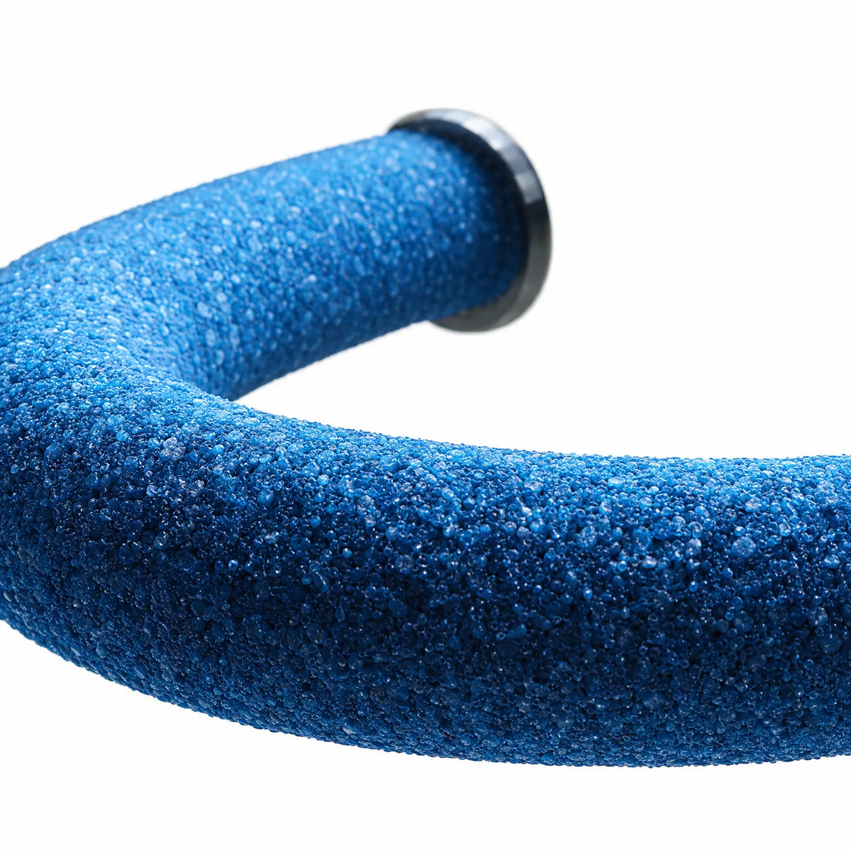 Close-up of the blue gritty perch surface, showing the coarse granular texture and the dark end fitting. 4