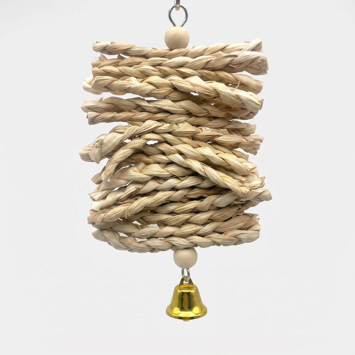 Hanging bird toy of stacked braided natural straw plaits with a wooden bead at each end and a small gold bell below, on a plain background. 1