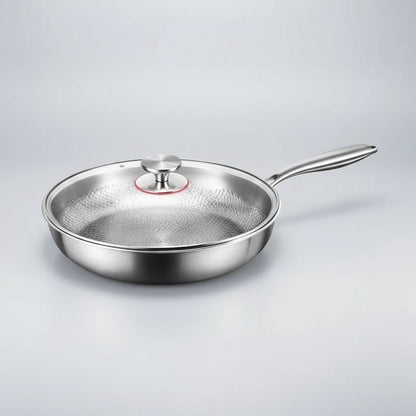 Pan with a clear glass lid and steel knob, shown from the side on a pale grey studio background. 8