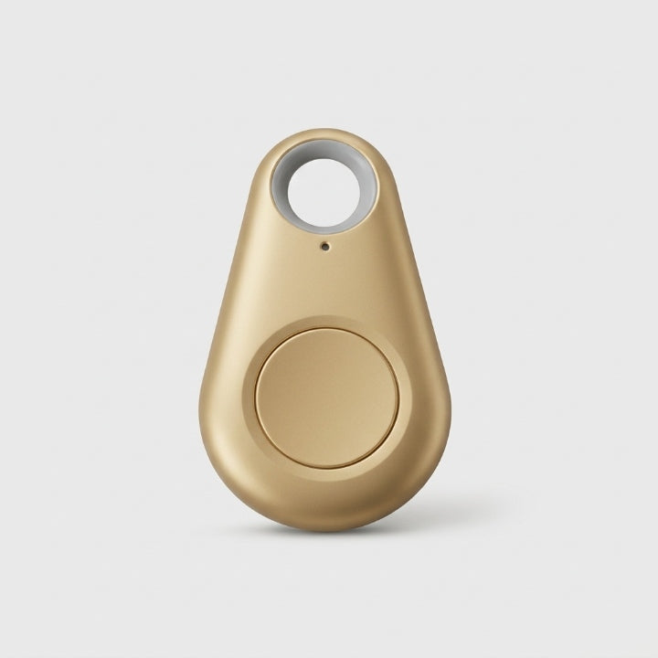 Gold teardrop-shaped tracker with a round central button and keyring hole, on a plain background 11