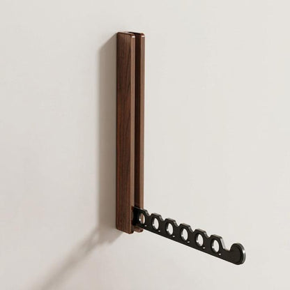 Walnut-effect rack fixed to a pale wall with its black six-hole arm pulled out, shown on its own. 6