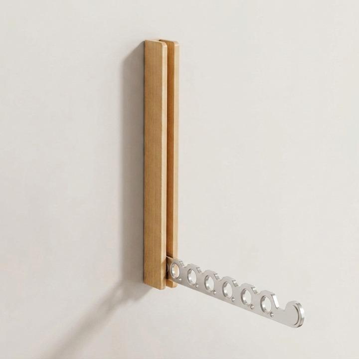 Light oak rack on a plain wall with its silver-toned six-hole arm folded out, shown on its own. 9