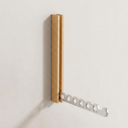 Light oak rack on a plain wall with its silver-toned six-hole arm folded out, shown on its own. 9