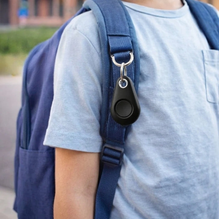 Black tracker attached by a split ring to the strap of a child's blue backpack 3