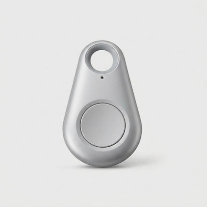 Silver-grey teardrop-shaped tracker with a round central button and keyring hole, on a plain background 10