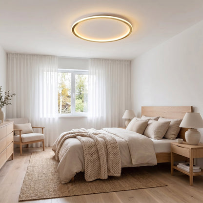 Gold ring ceiling light above a bright bedroom with a wooden bed and chunky knit throw 5