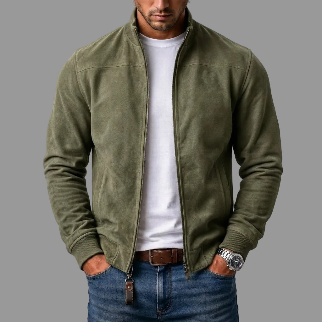 Olive green zip-up jacket worn open over a white T-shirt and jeans, with ribbed cuffs and a leather zip pull. 3