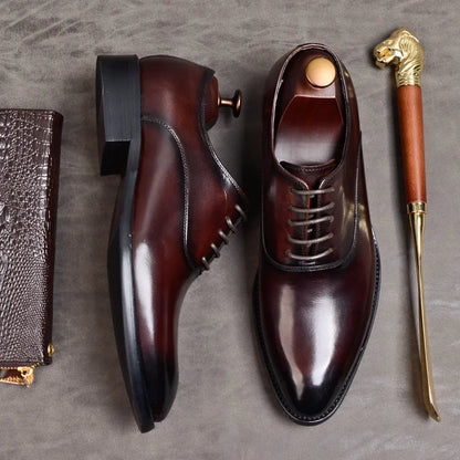 Burgundy leather shoes in a flat lay, one on its side showing the stacked heel, next to a shoehorn 6