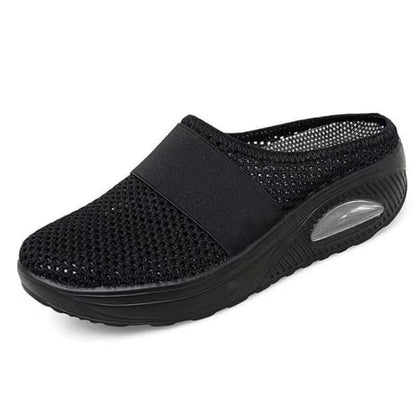 All-black mesh backless slip-on with elastic strap and clear air cushion window in the heel 10