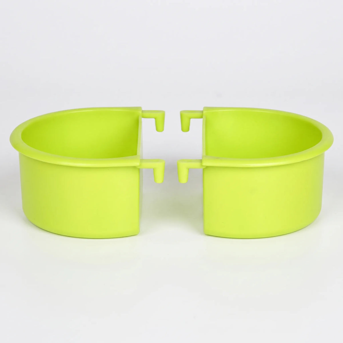 Two green plastic half-round feeding bowls shown side by side against a plain white background, each with two small hooks for hanging. 1