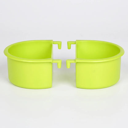 Two green plastic half-round feeding bowls shown side by side against a plain white background, each with two small hooks for hanging. 1