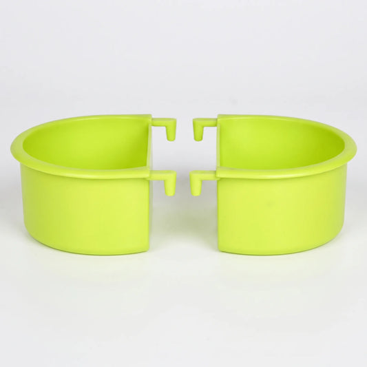 Two green plastic half-round feeding bowls shown side by side against a plain white background, each with two small hooks for hanging. 1