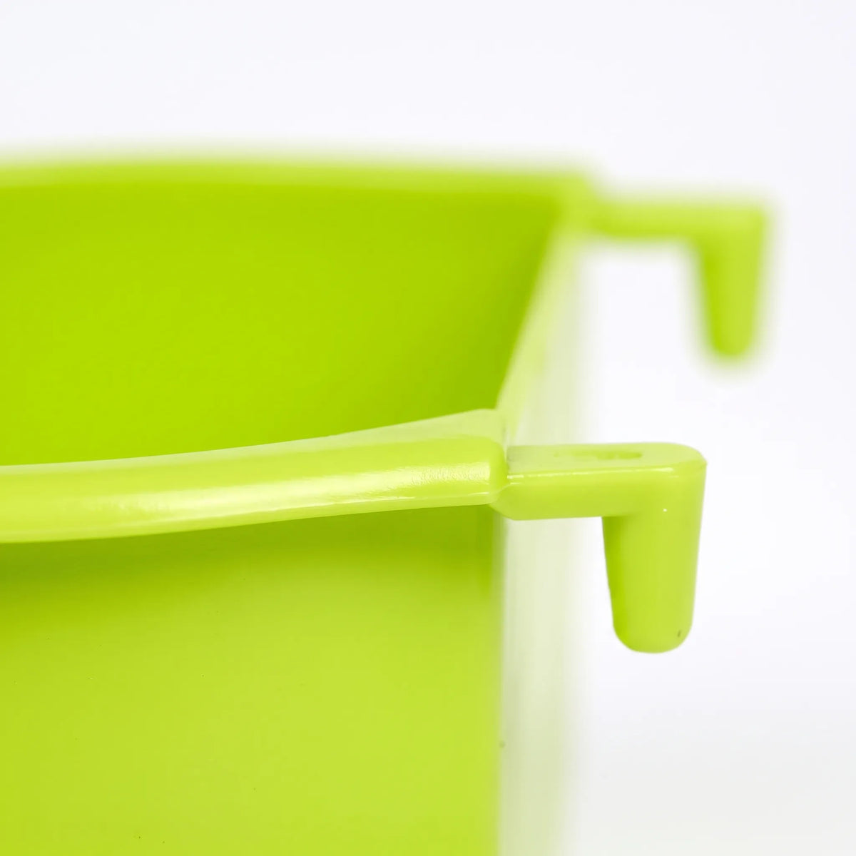 Close-up of one of the bowl's hooks on the rim, showing the smooth green plastic and the shape of the hanging catch. 3