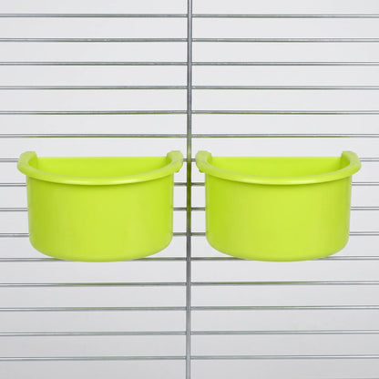 Two green half-round bowls hung side by side on the wire bars of a metal cage. 4