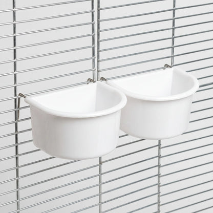 Two white half-round bowls hanging on a cage grille, held in place by thin metal wire hangers. 7