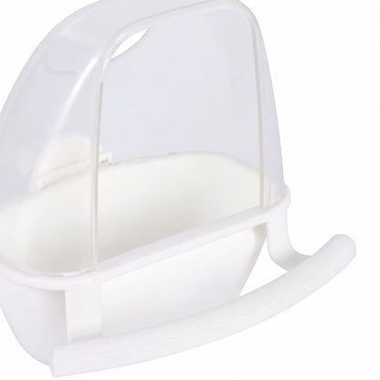 Close-up of a white feeder with a clear hood and curved perch, showing the shape of the bowl and hood. 3