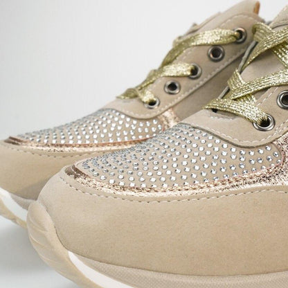 Close-up of the toe area of a pair of beige trainers, showing crystal-studded panels, gold laces and a white sole. 10