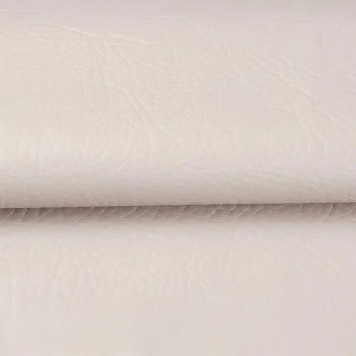 Close-up of the textured cream patch material, folded across the middle 10