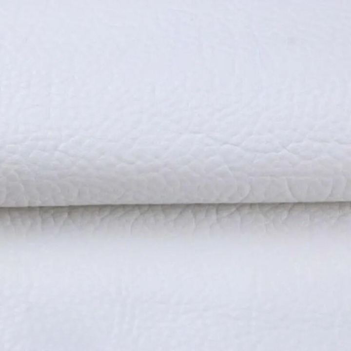 Close-up of the textured white patch material, folded across the middle 11