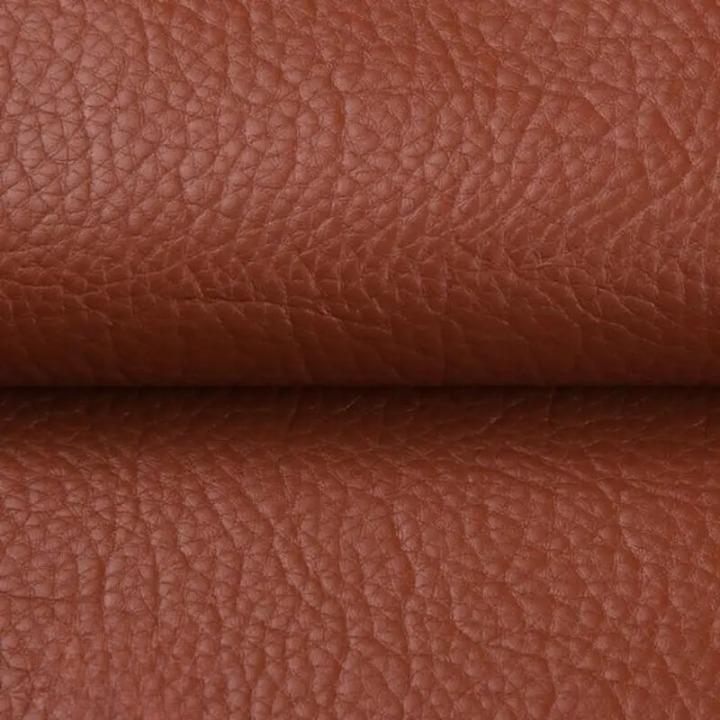 Close-up of the textured tan-brown patch material, folded across the middle 12
