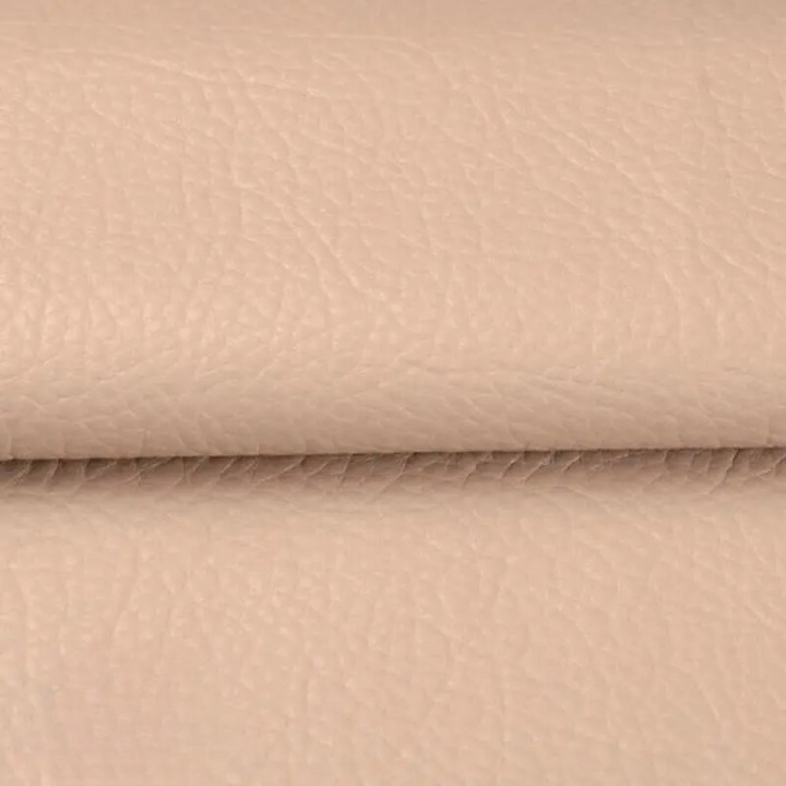 Close-up of the textured pale beige patch material, folded across the middle 15