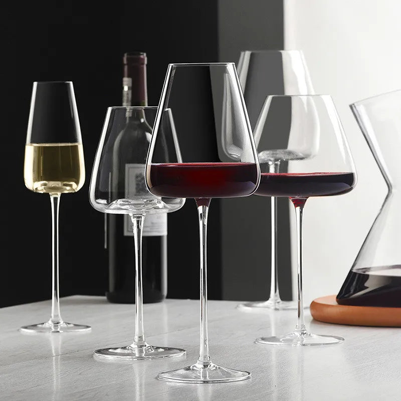 Red wine glass in front of a champagne flute, white wine glass, wine bottle and angular decanter 5