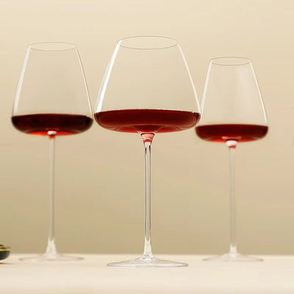 Three red wine glasses of different sizes lined up against a soft cream background 10