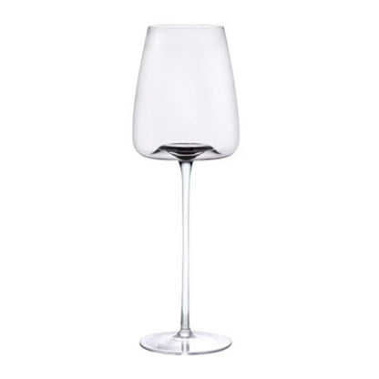 Single empty tulip-shaped wine glass with a slim stem and a faint grey tint on white 11