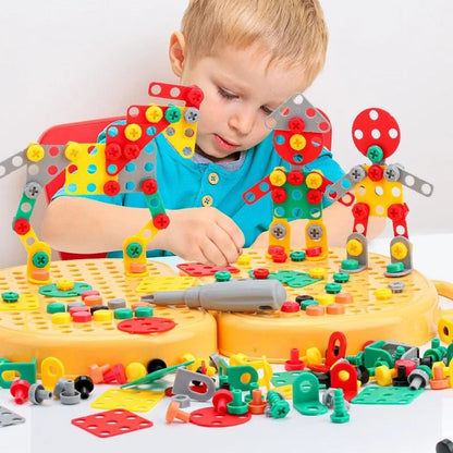 Boy sits at a table building colourful robot figures from plastic plates, bolts and nuts on the yellow pegboard case. 2