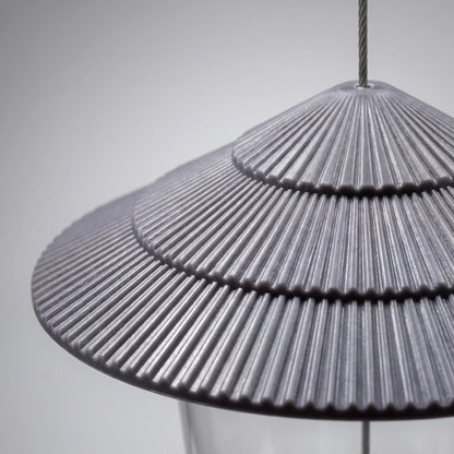 Close-up of the grey tiered, ridged roof with the steel hanging wire passing through its top. 3