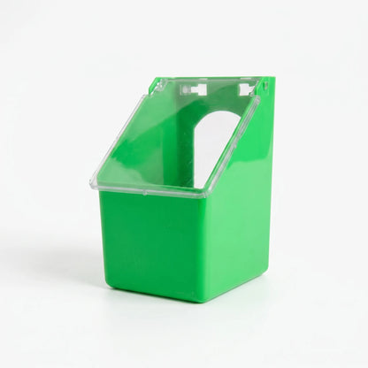 Single-compartment green feeder from a three-quarter angle with the clear lid closed, showing the arched bird opening behind it. 4