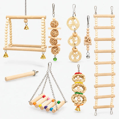 Full set of wooden bird toys on white: bead swings, ladder, loofah and rattan chews, a perch and small bells. 1